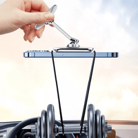 Magnetic car phone mount on dashboard with clamp-style holder, hand adjusting the arm