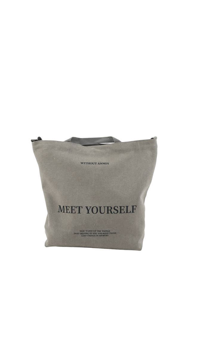 Gray canvas tote bag with printed 'MEET YOURSELF'.
