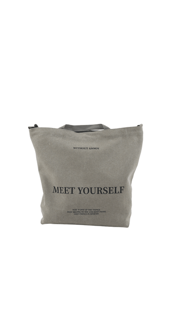 Gray canvas tote bag with printed 'MEET YOURSELF'.