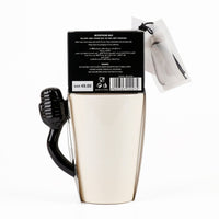 Beige ceramic karaoke cup with black microphone handle shown in back-of-pack packaging