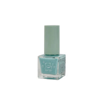 Light blue nail polish bottle with tall cap, front label visible