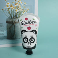 Hand cream tube with panda face illustration and rose flowers, on squeeze base