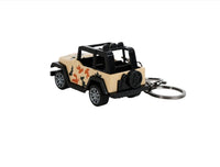 Mini Jeep keychain in beige with camo patches and key ring, side view.