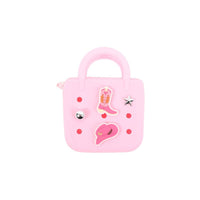 Pink mini silicone handbag with handle, front charms and star patch detail