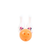 Orange bowling ball with three white Minnie pins behind, pink bows