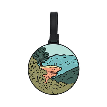 Round luggage tag with black strap, nature landscape illustration in teal and green
