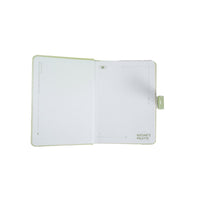 Pastel magnetic buckle notebook open, lined pages with green side clasp