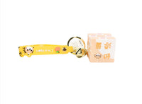 Yellow tiger cube keychain with clasp, gold keyring, and small bell