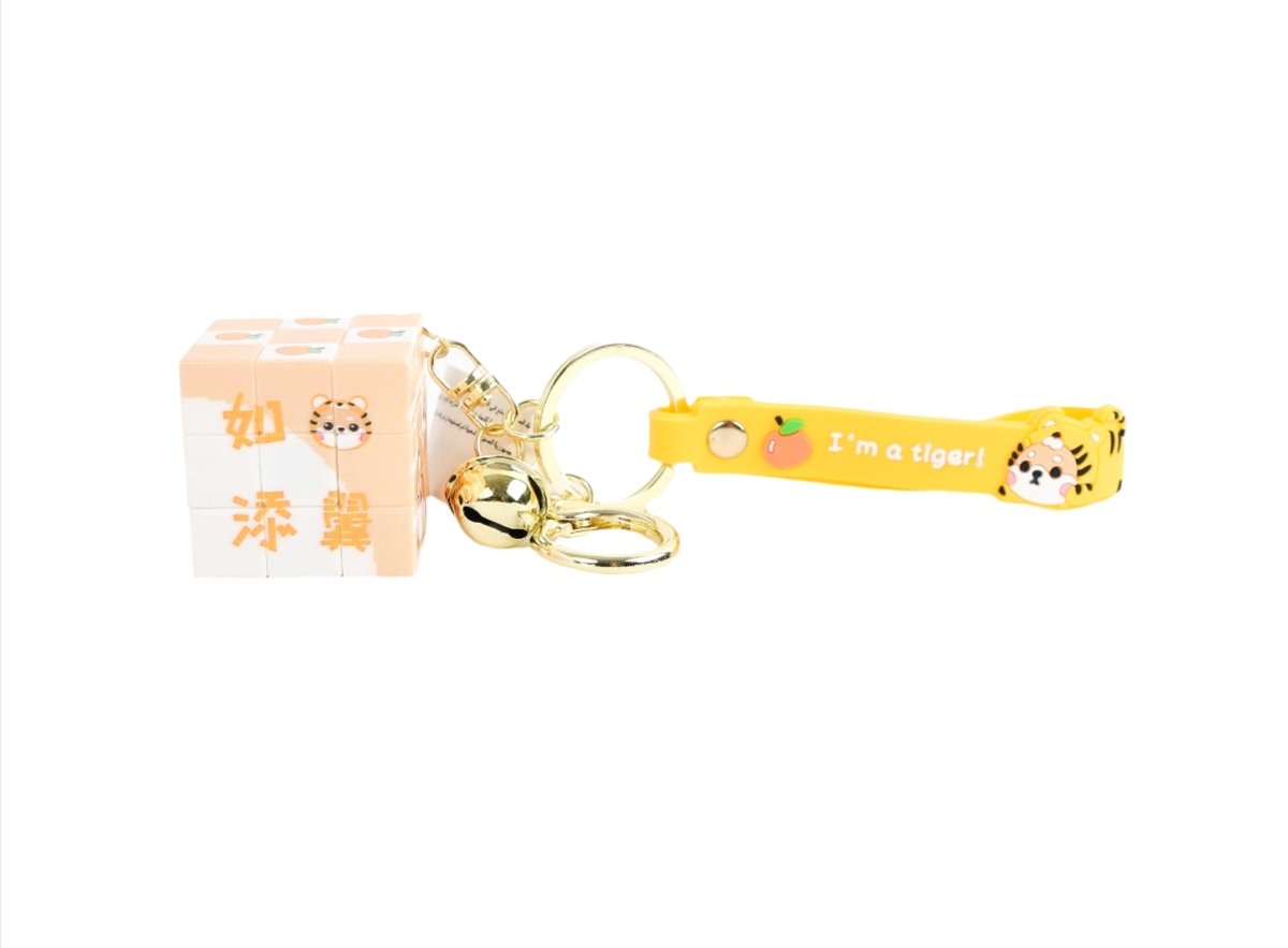 Tiger cube keychain with pale orange cube charm, gold keyring, and bell
