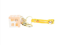 Tiger cube keychain with pale orange cube charm, gold keyring, and bell