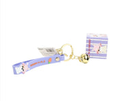 Blue fabric keychain strap with bunny tag charm, gold ring, and bell