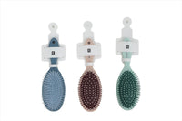 Hair brush set for scalp massage: blue, maroon, and green brushes on display
