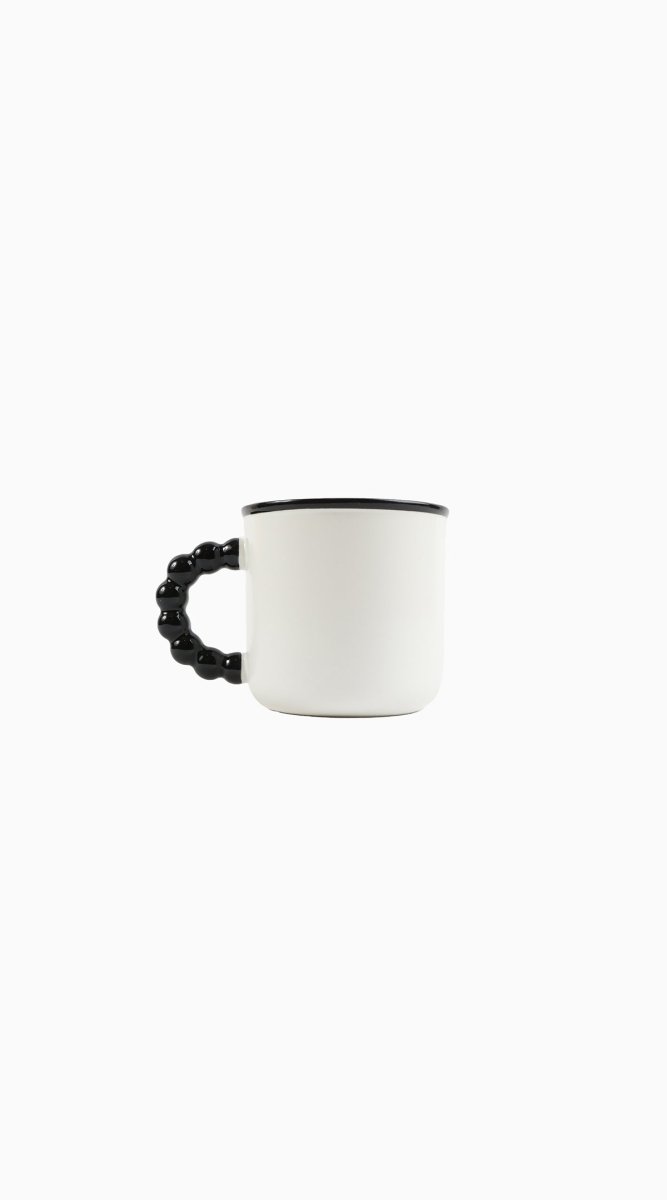 Ceramic panda mug side view with black beaded handle and dark rim on white cup