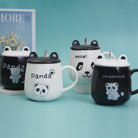 Assorted ceramic panda cups with lids and spoons, white and black designs