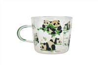 Glass mug with panda faces and bamboo graphic, clear body and side handle