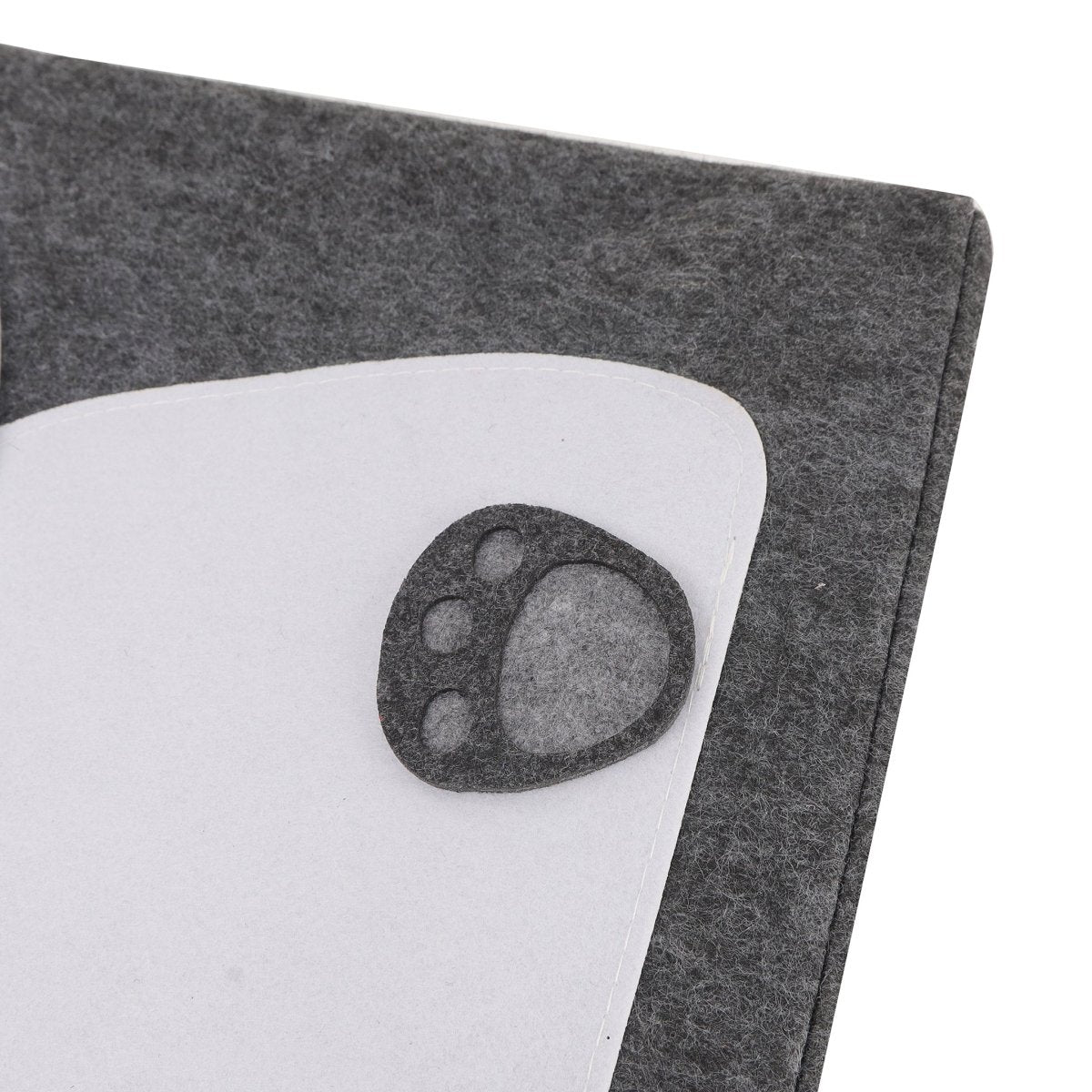 Panda laundry basket corner with paw-print patch on dark gray felt fabric