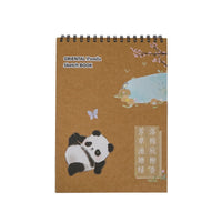 Spiral-bound sketchbook with panda cover, butterfly and blue cloud scene