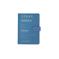 Blue pastel notebook with magnetic buckle strap; cover text reads STRAY BIRDS