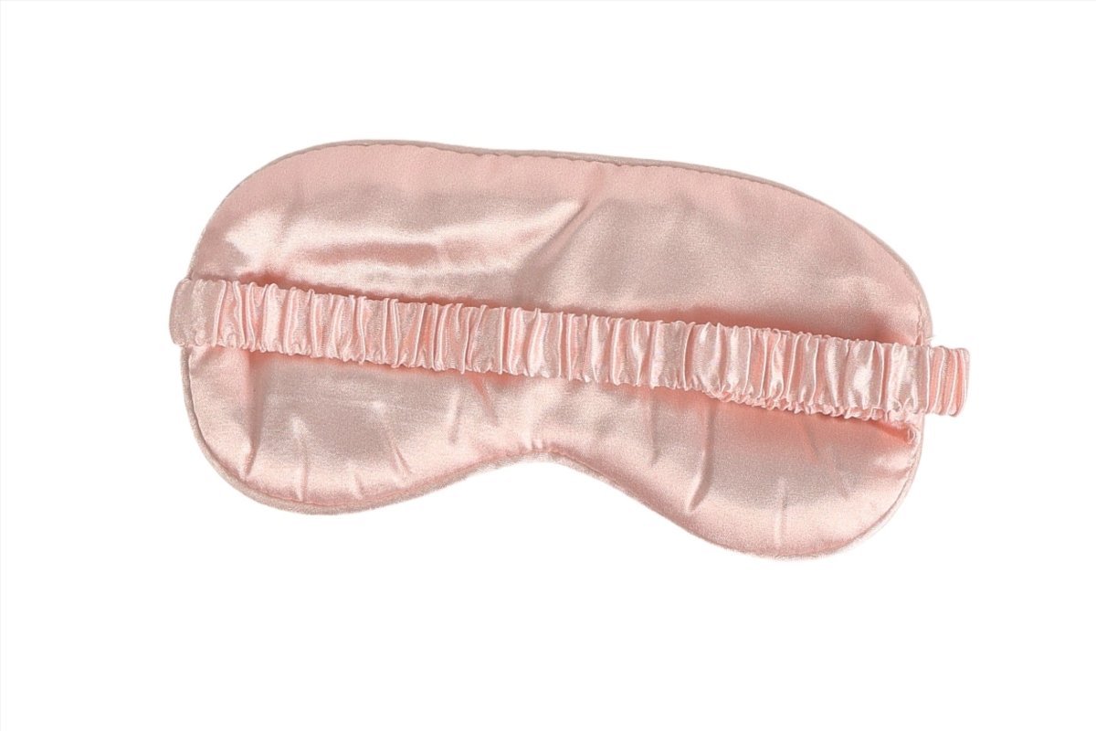 Peach pink satin sleep mask with gathered elastic band and smooth underside