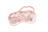 Peach pink silk sleep mask with fruit and flower print, soft elastic strap