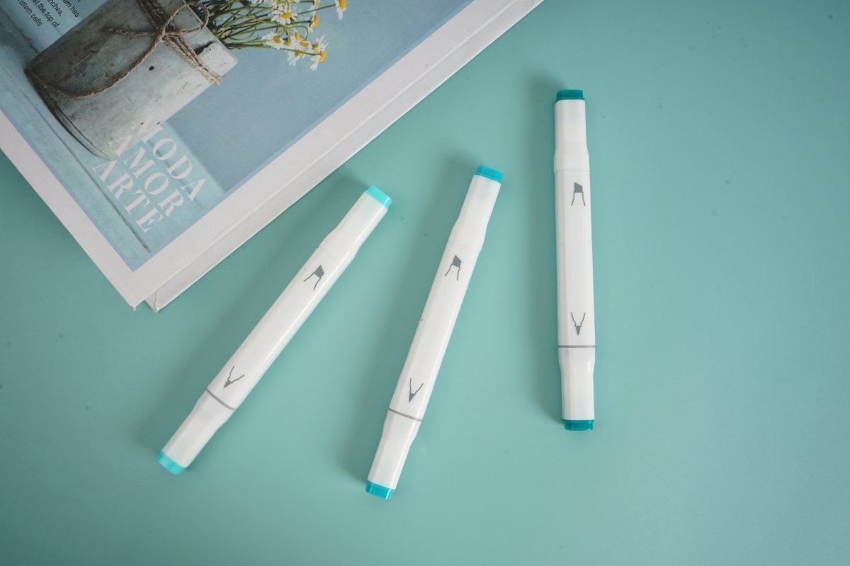 Three white highlighters with teal caps and V-marking tips, shown at different angles