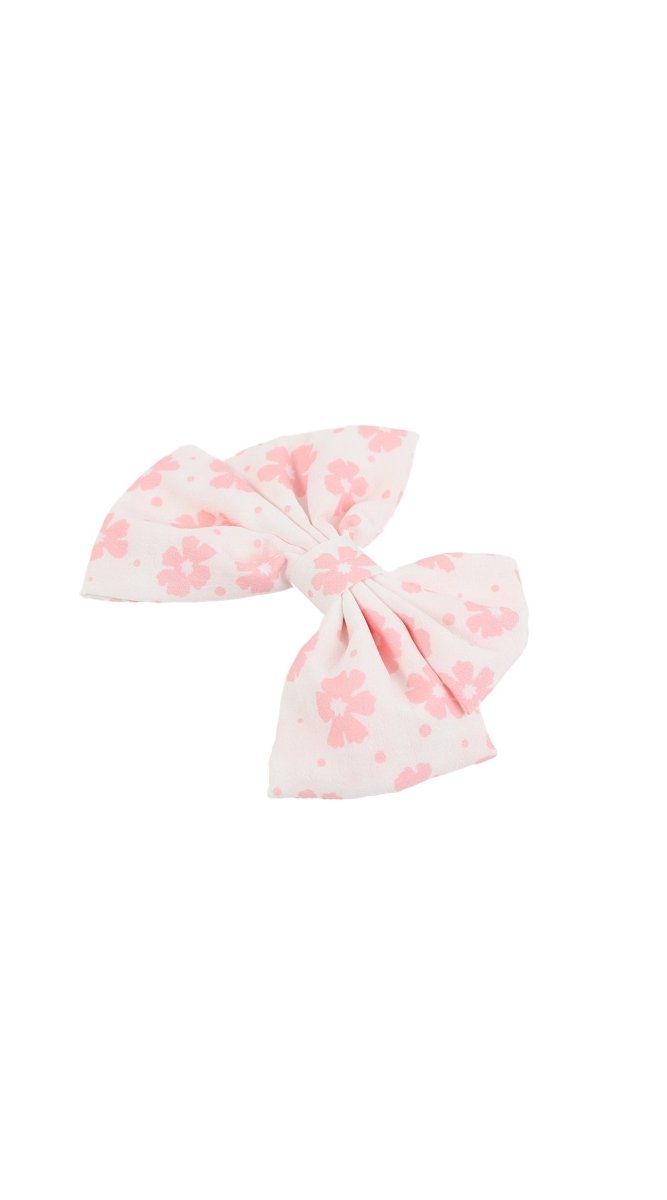 Pink floral hair bow clip with layered bow ends and knot
