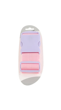 Pink luggage strap connector with gray latch and stacked webbing loops, close-up.