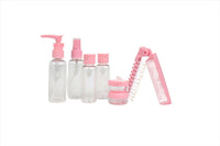 Pink travel toiletry set with pump bottles, compact jar, and folding comb