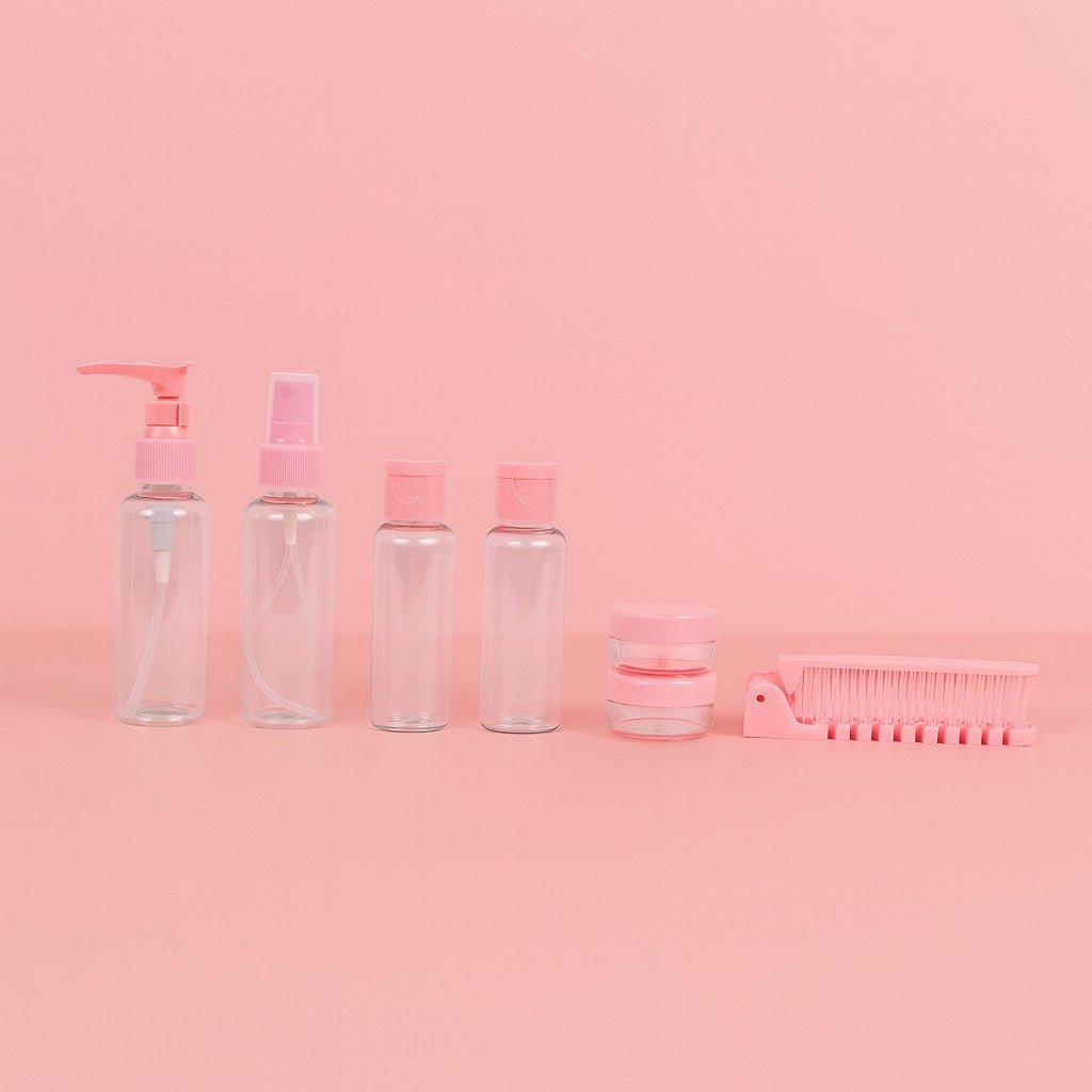 Pink travel toiletry set with pump bottles, jars, and comb accessory