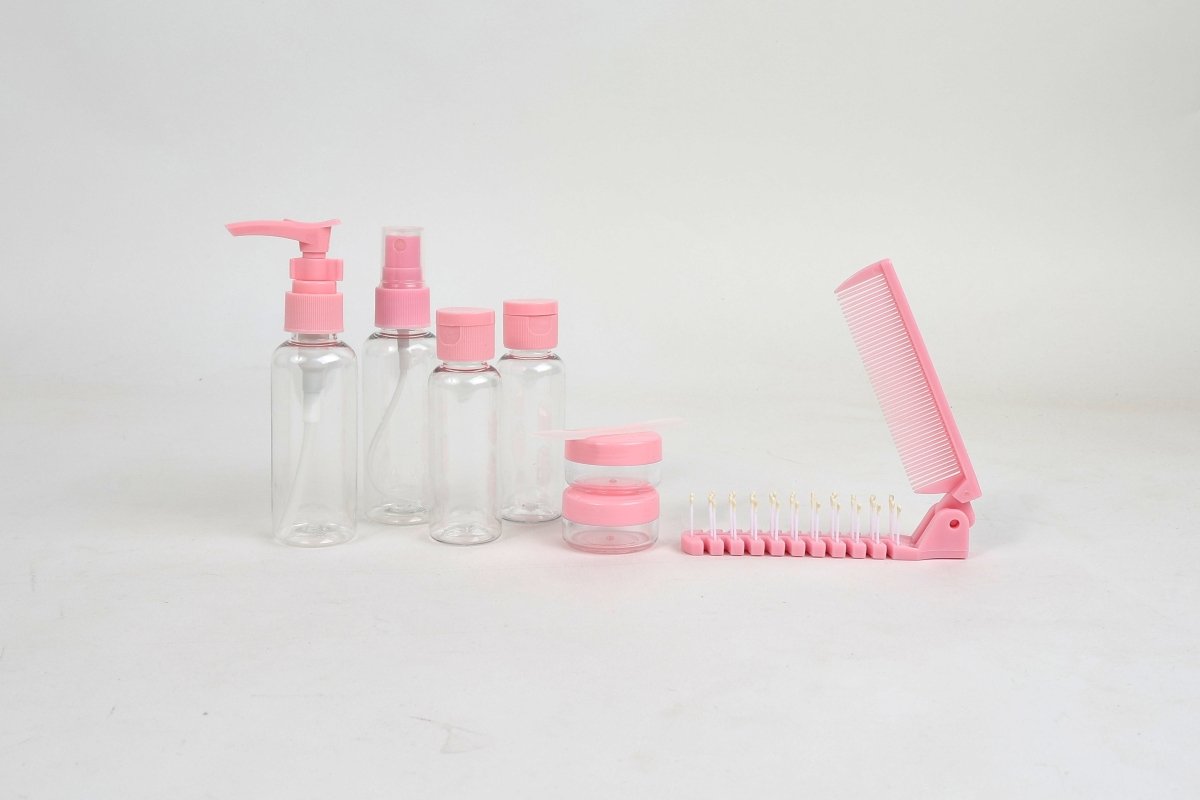 Pink travel toiletry set with pump bottle, mini bottles, jar, and folding comb