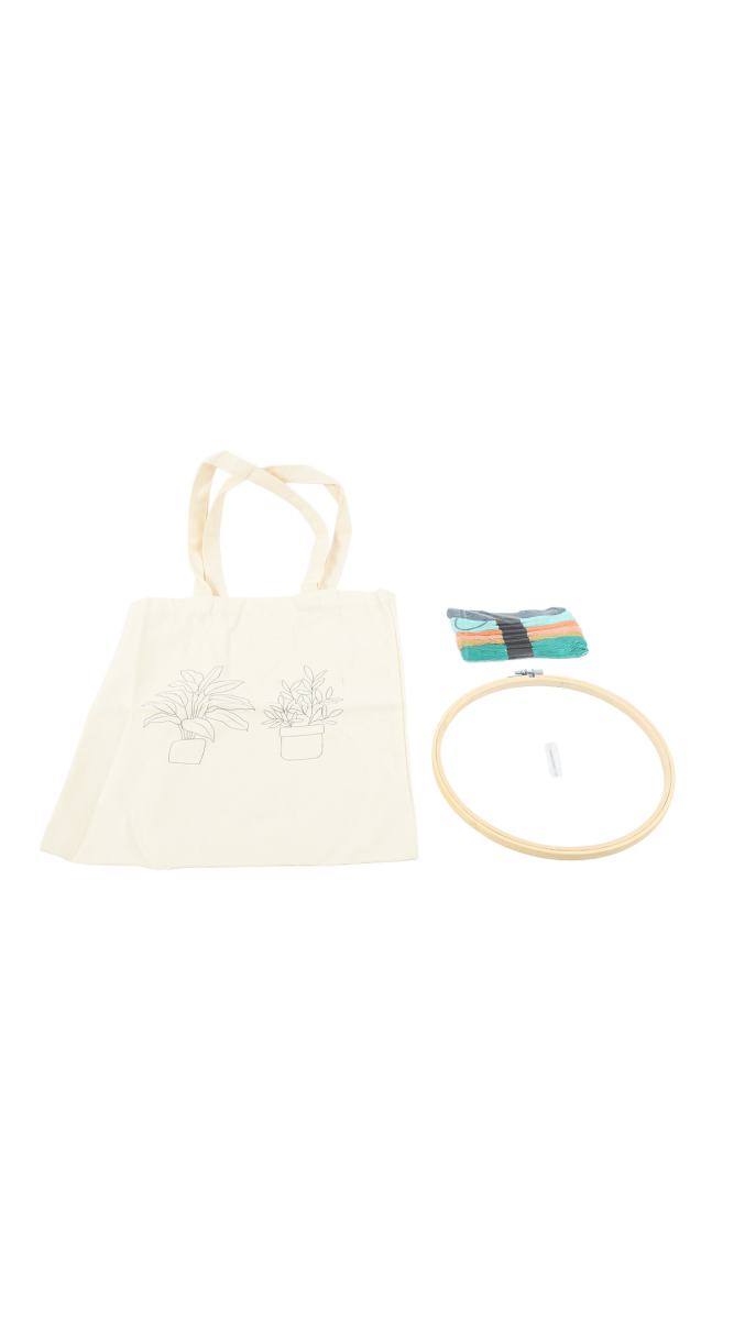 Off-white tote bag with plant outline, embroidery hoop and multicolor thread set