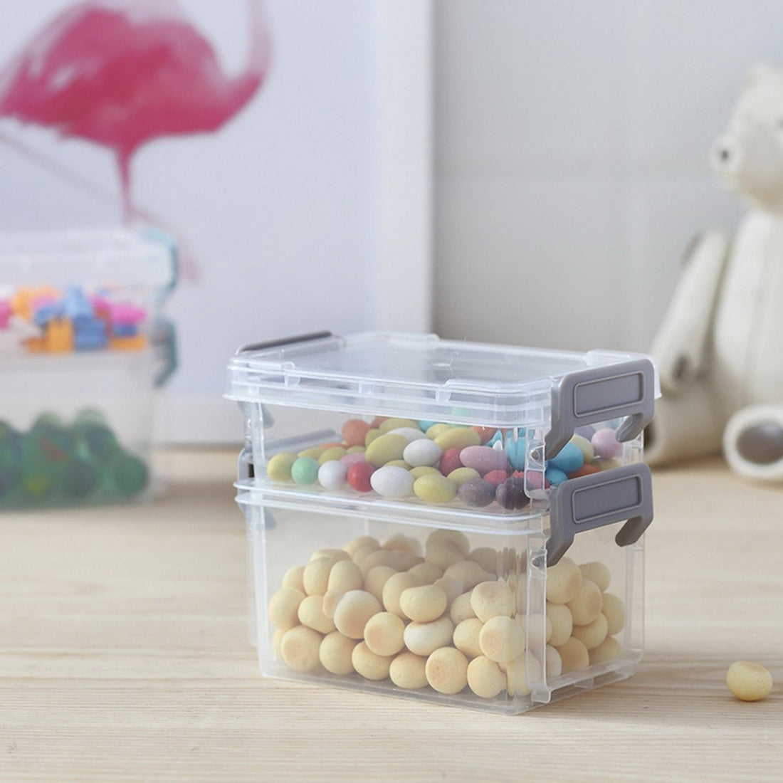 Clear plastic storage container with snap latches, filled with multicolor beads