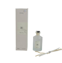 Reed diffuser bottle with plum tea scent, clear glass and metal cap
