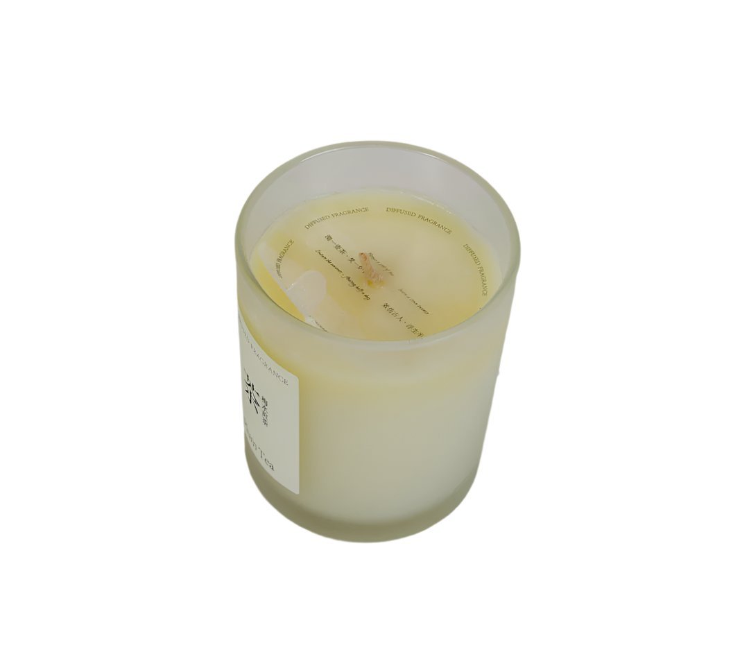 Plum tea scented candle in frosted glass jar, wax top view