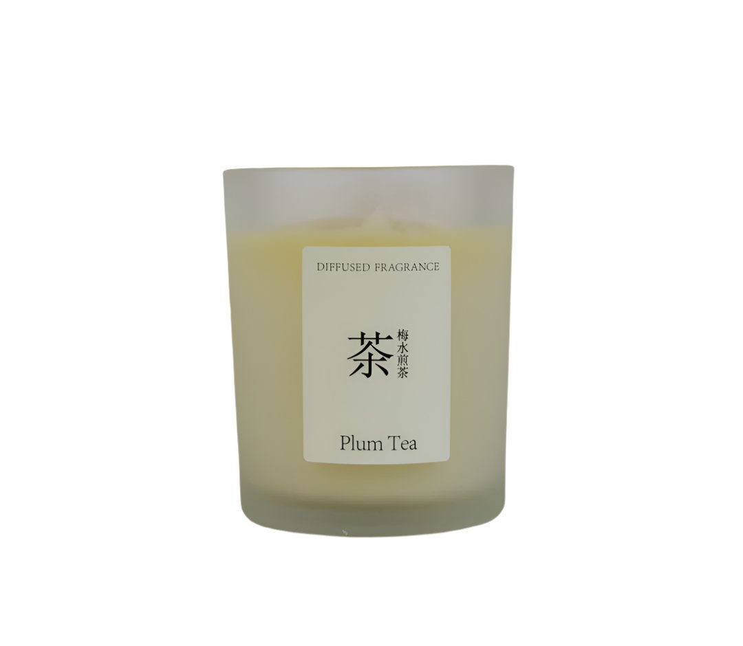 Plum tea scented candle in frosted glass jar with centered label