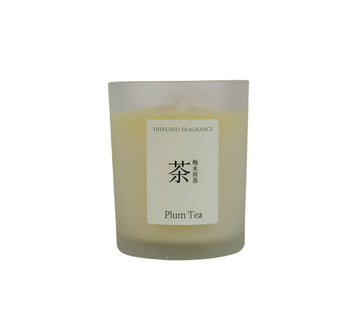 Plum tea scented candle in frosted glass jar with centered label