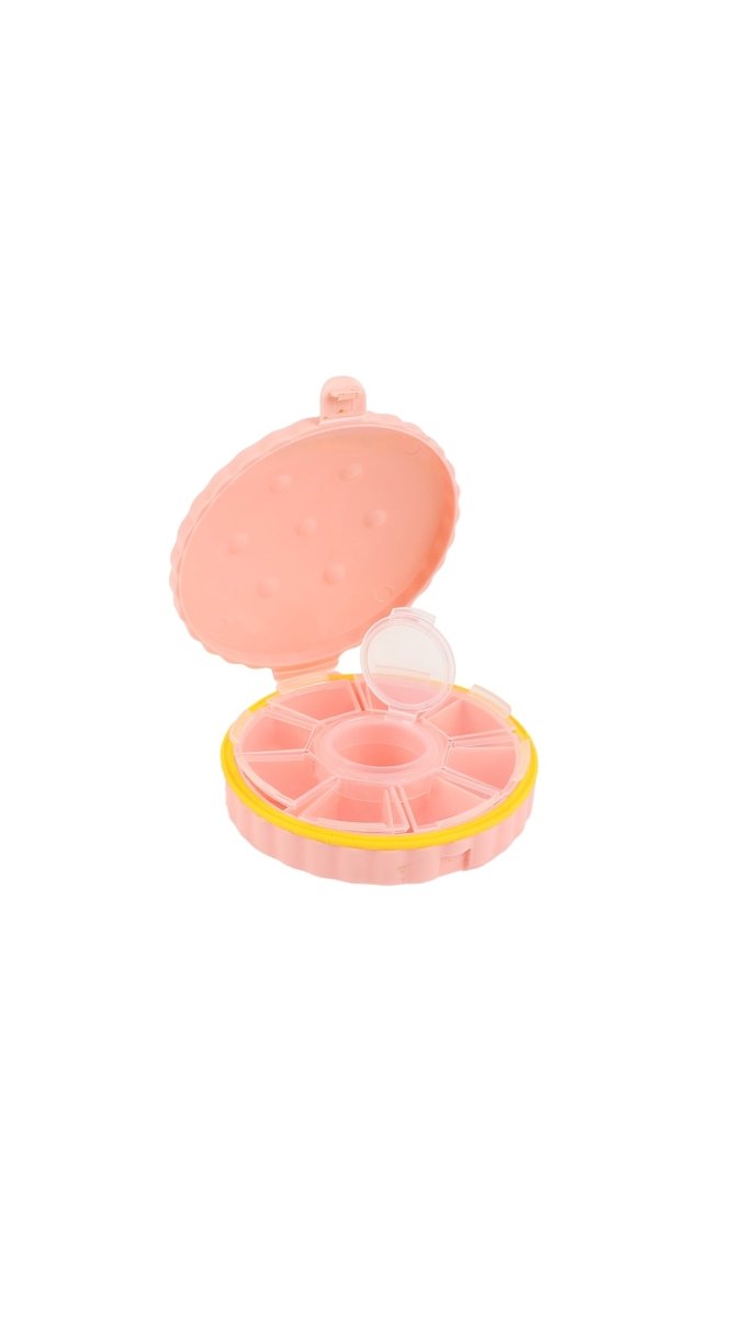 Pink portable pill box with hinged lid open, showing 4 circular compartments