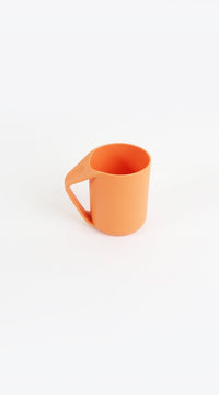 Orange plastic cup with handle, open top, curved spout