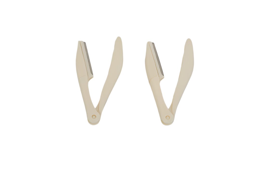 Precision eyebrow razors, two beige tools with curved cutting edges