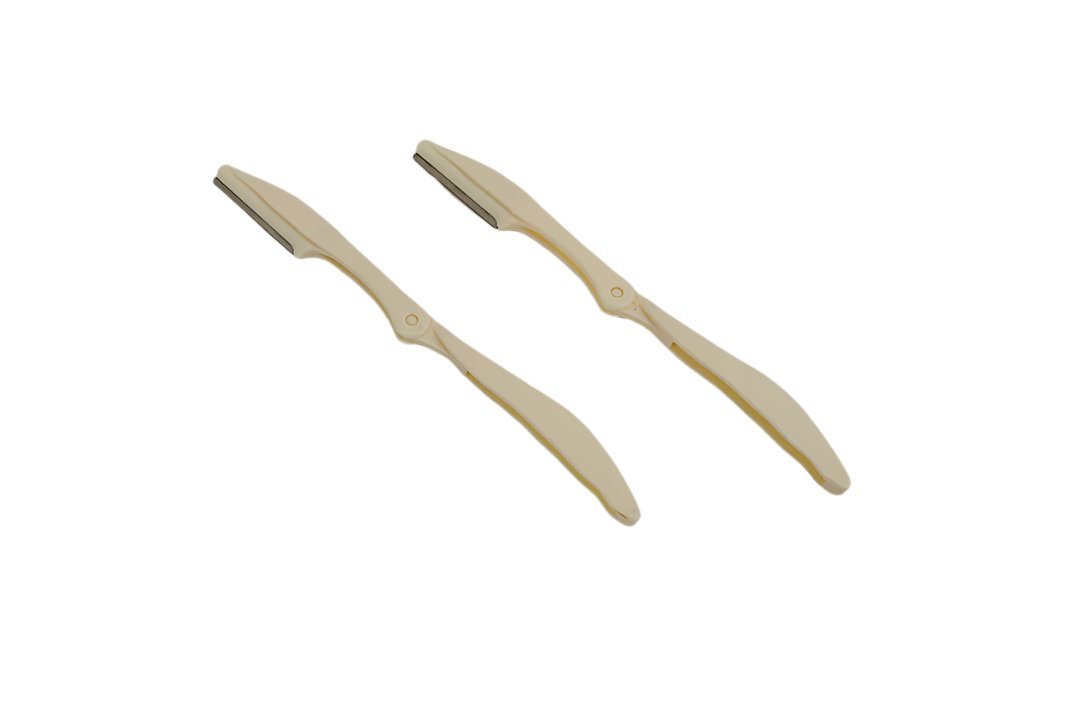 Precision eyebrow razors, two beige handheld tools with angled blades