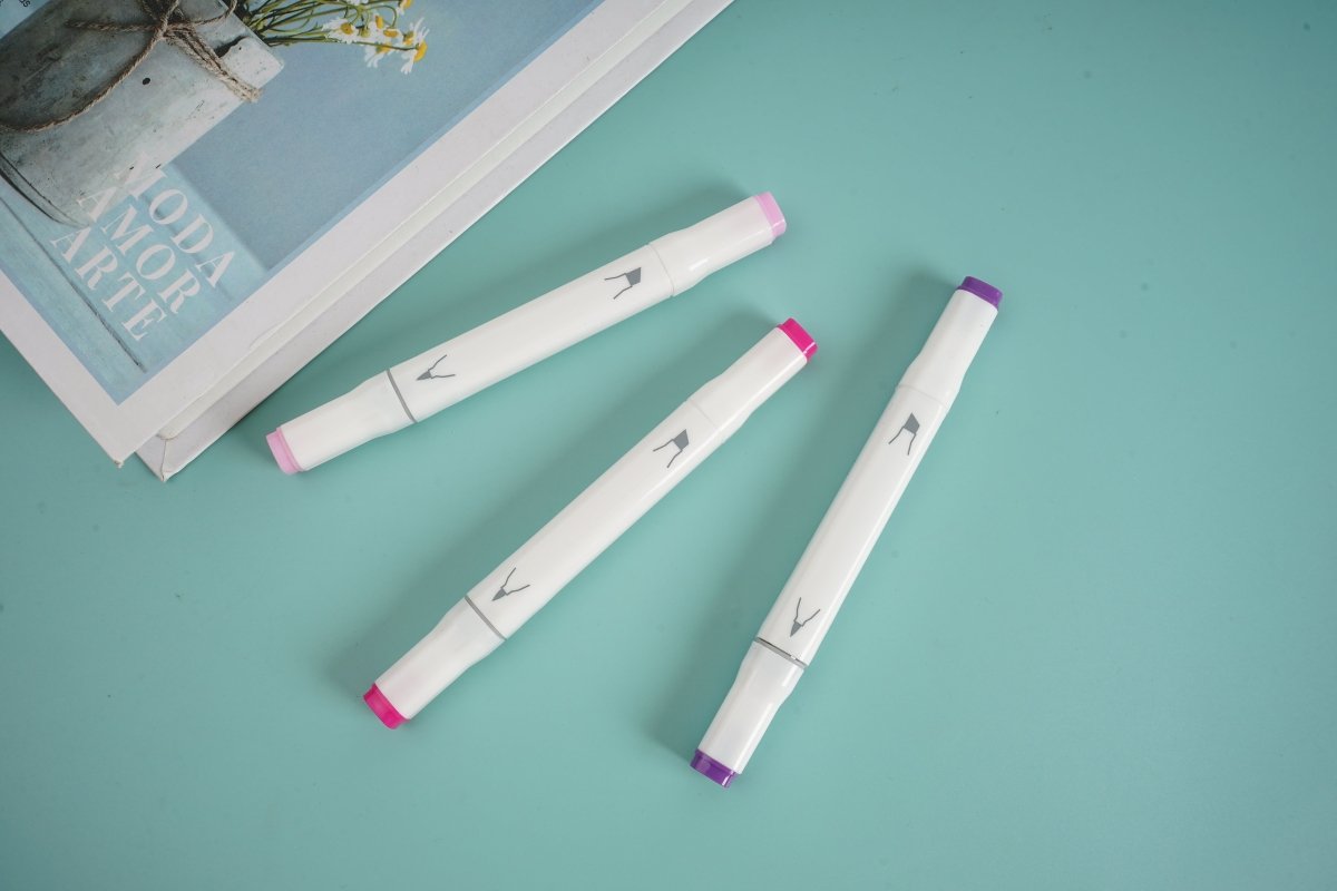 Set of three purple-tipped highlighters lying on a flat surface