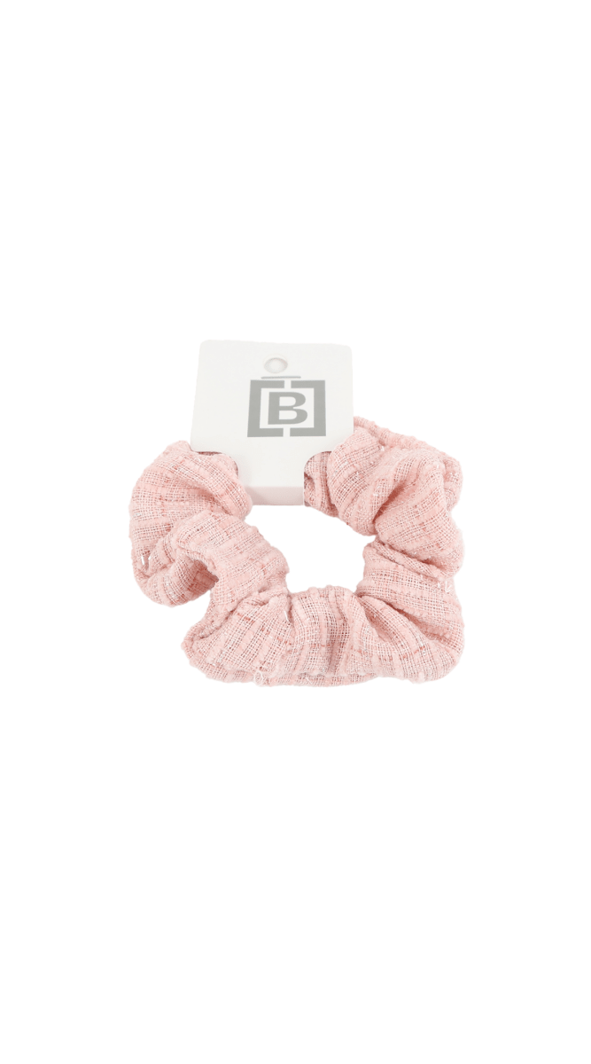 Woven hair scrunchie in soft pink, gathered knit texture
