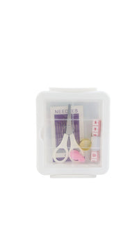 Sewing kit storage box with sewing tools: scissors, needle pack, thread, and tape measure
