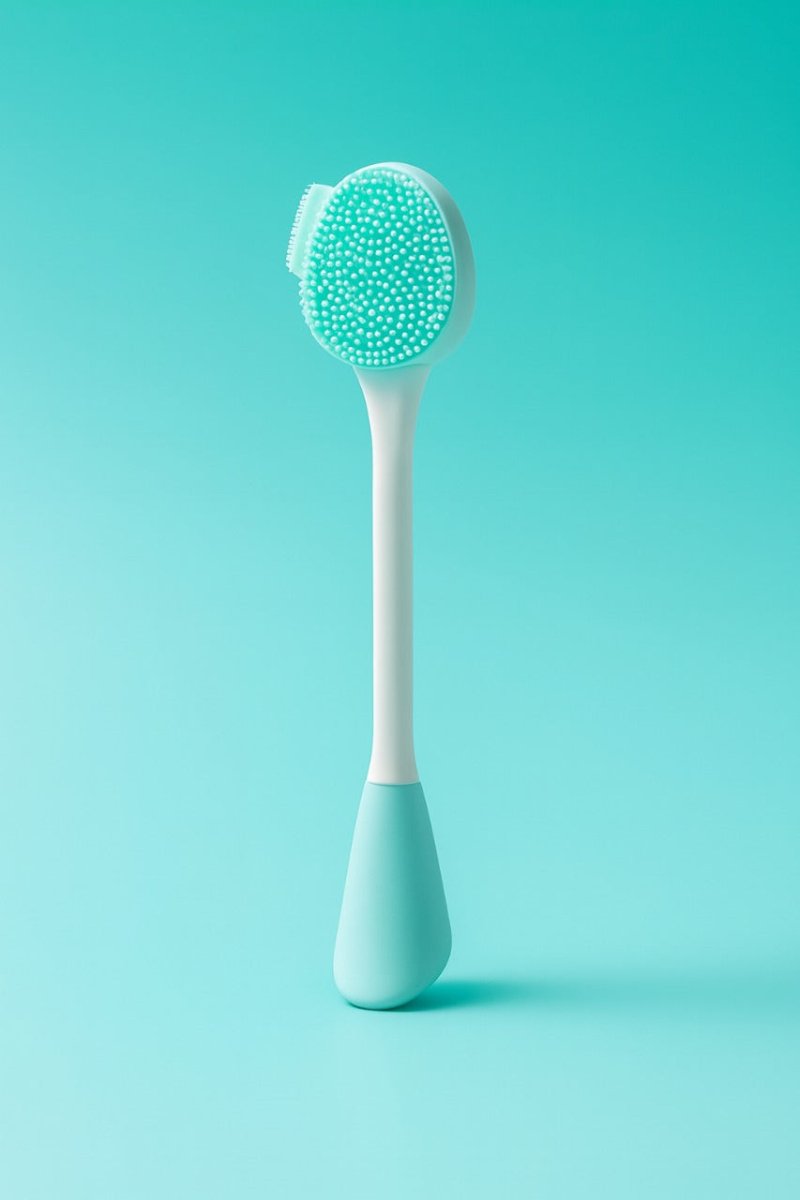 Silicone facial cleansing brush with green textured head and white handle