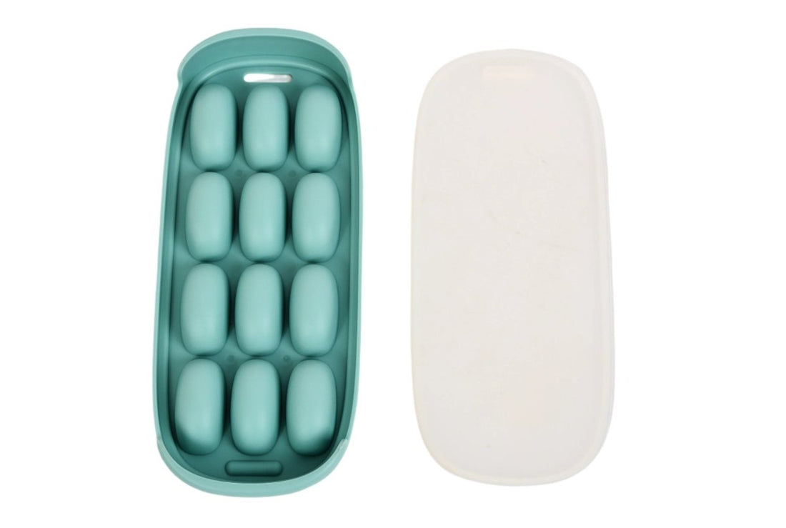 Silicone ice cube tray, green interior with 12 oval cavities and white lid