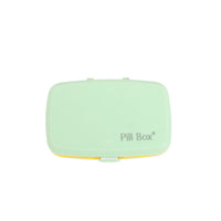 Six-cell pill organizer box with closed lid, light green exterior
