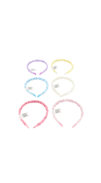 Six pastel fabric hairbands with small rectangular tags; lilac, yellow, white, blue, pink, cream.