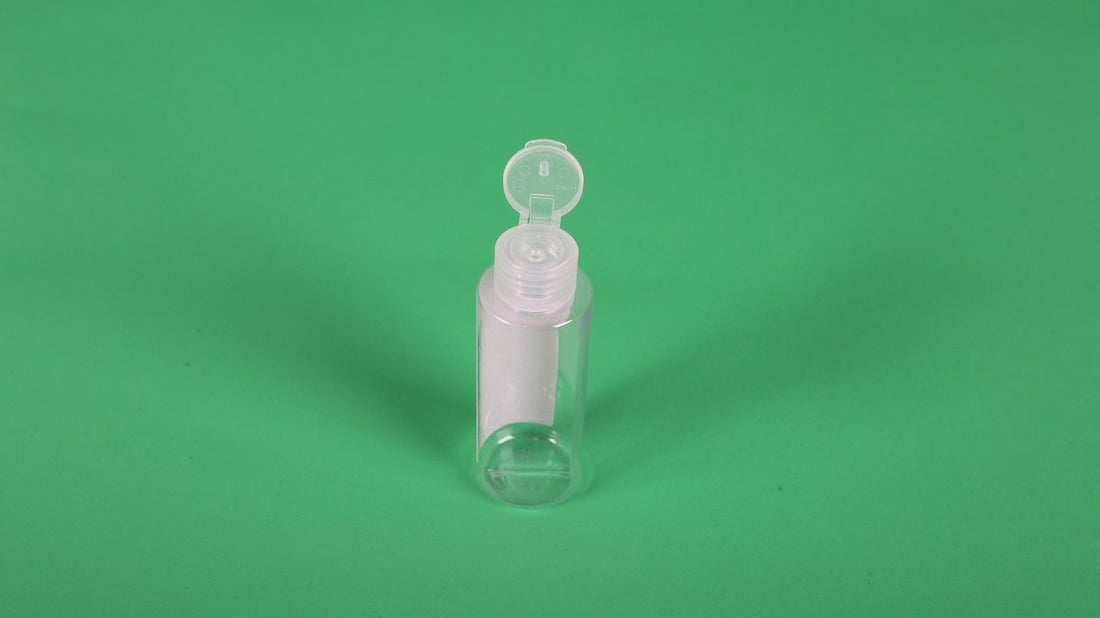 Small empty plastic bottle with flip-top cap, clear body