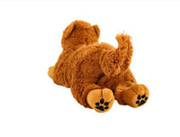 Brown puppy plush toy lying on back with paw prints and fluffy tail