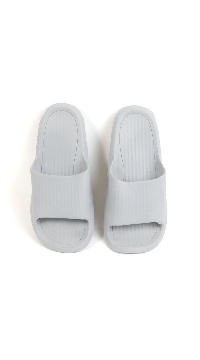 Light gray bathroom slippers with molded footbed and ribbed upper openings